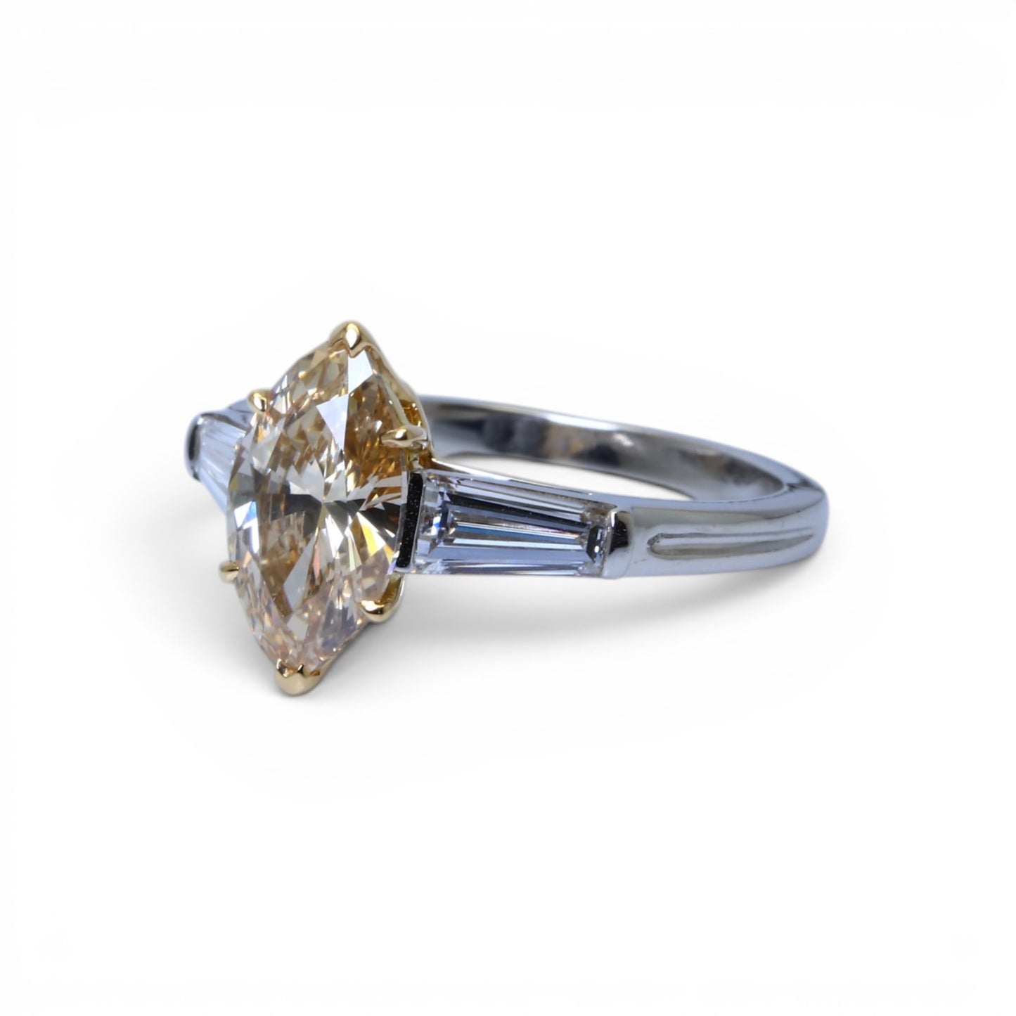 Bague solitaire ornée d’un diamant taille navette et de diamants baguettes.