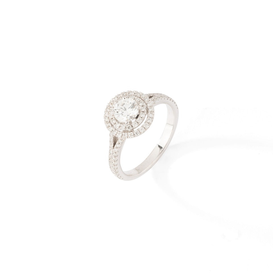 Bague solitaire en or blanc et ornée de diamants taille brillant.